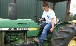 Female Member driving tractor