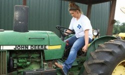 Female Member driving tractor