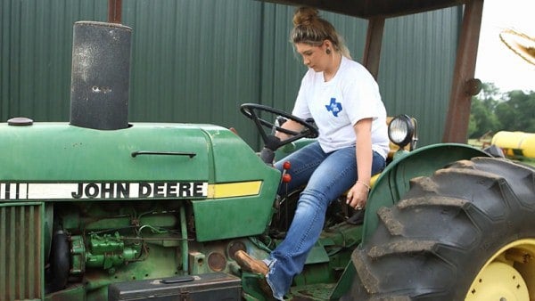 Female Member driving tractor