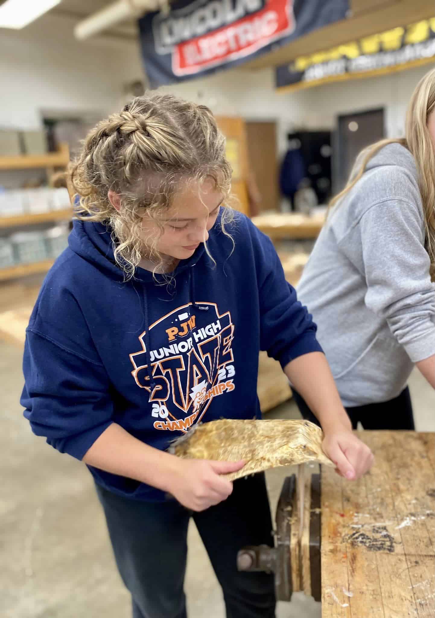 After applying treatments, Athens Middle School FFA members work their hides until the finished product is ready to be taken home.