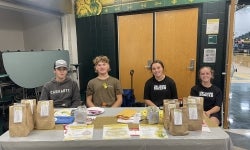 FFA members volunteered to help collect donations at the volleyball game.