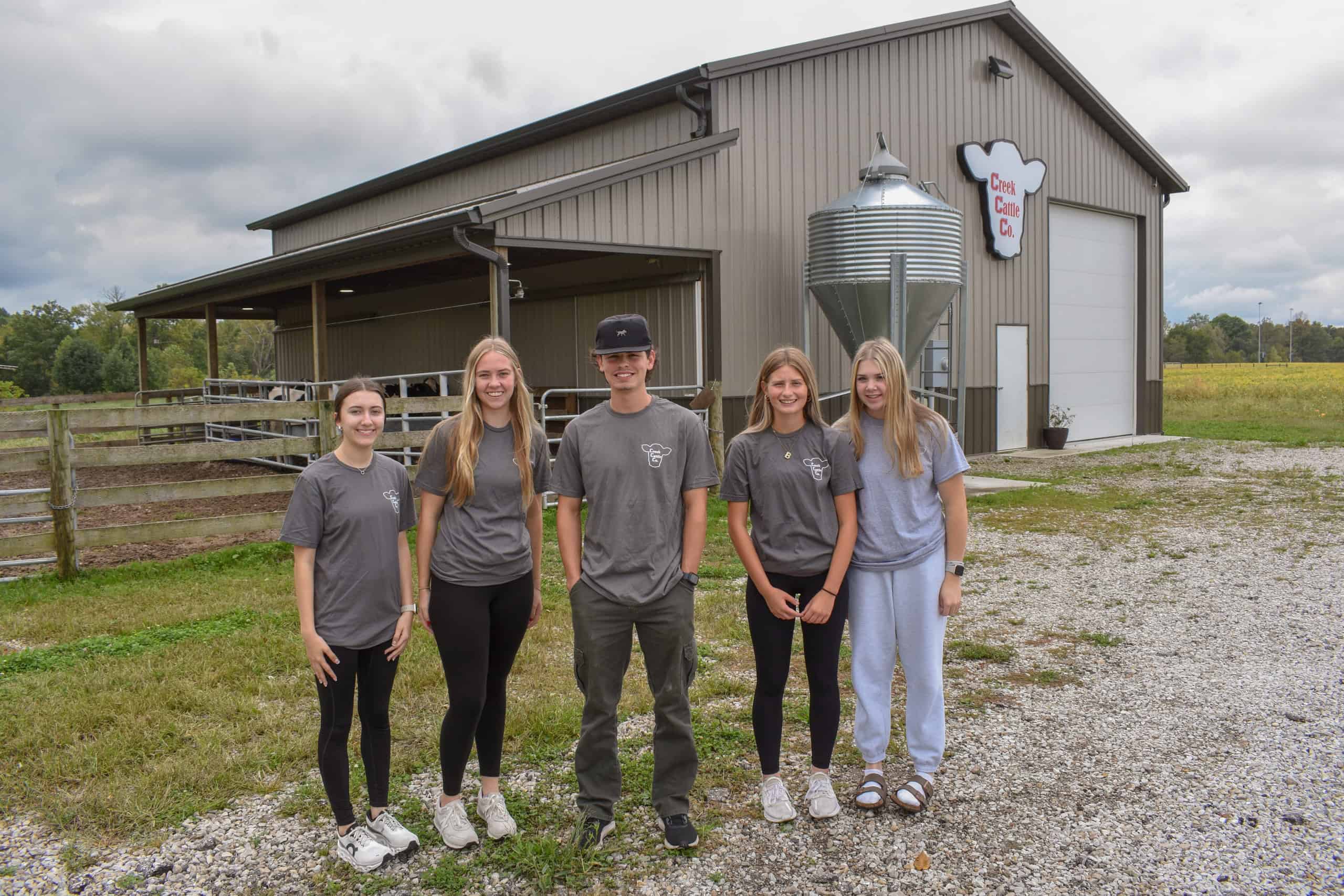Creek Cattle Company management team stands in front of the company's facility.