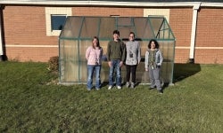 Cord Akey with teachers and the principal from Country Meadow Elementary.