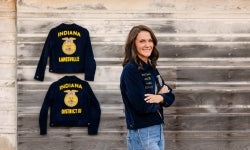 Margeaux Stewart, standing by her FFA jackets, showcasing her growth within the organization.