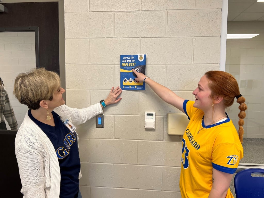 Beauregard FFA member Lilly Stallions (right) shares plans for the Inflation Station with Beauregard High School faculty and staff. Photo courtesy of Jerad Dyess.