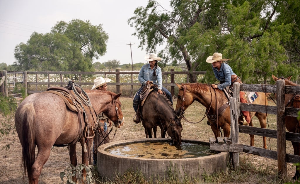 Interning on several cattle ranches helped Gina Tran (center) find her chosen career path in agriculture. Photo by Knox Kronenberg.
