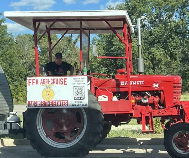 Koehn pauses for a photo with his 1940 Farmall “M” tractor during his travels. Photo courtesy of Mark Koehn.