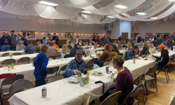 A large crowd of all ages enjoying the benefit steak dinner in Calamus, Iowa. The labor auction followed the dinner for approximately one hour