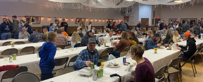 A large crowd of all ages enjoying the benefit steak dinner in Calamus, Iowa. The labor auction followed the dinner for approximately one hour