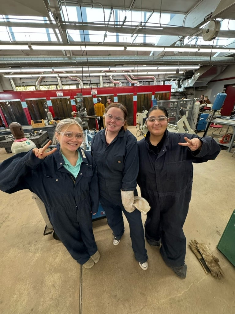 Harmony Marie DeCastro (left), Brianne Shannon (center) and Viviana Velazquez (Right) prepare to weld in the agricultural mechanics shop.