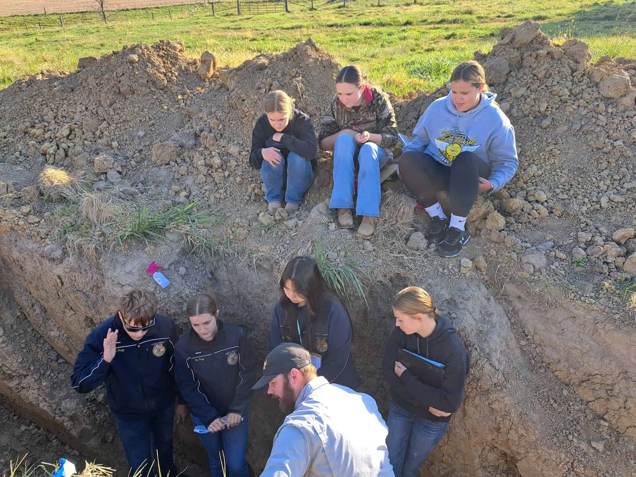 Team out in a pit, while being coached by Brandon Hall