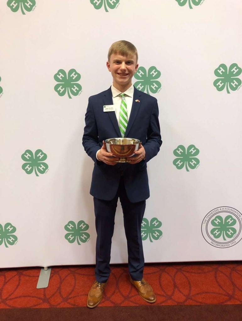 Harville smiles with his award at the Tennessee 4-H Public Speaking Championship.