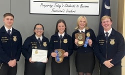 Five people posing for a picture.