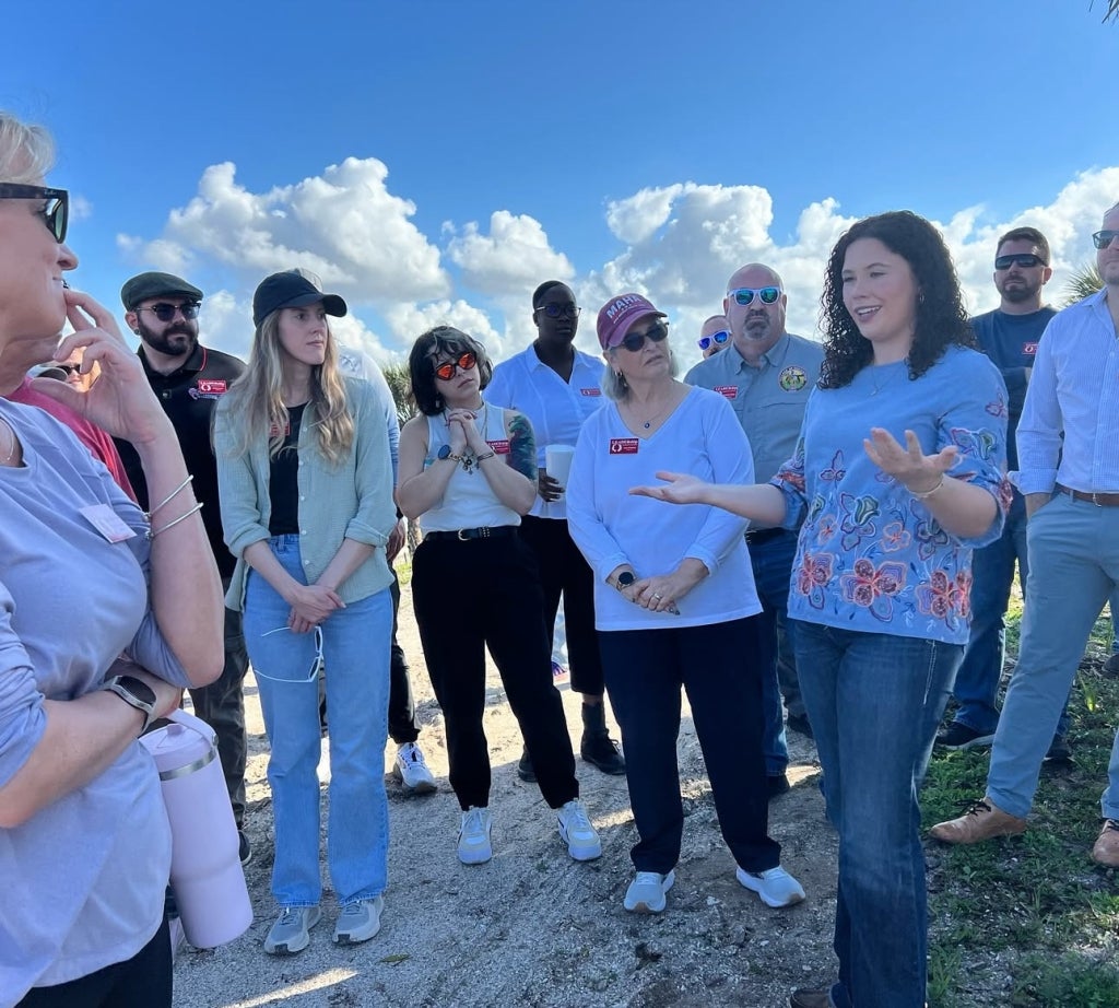 Paige Cruse talking to a tour group about local agriculture advocacy. 