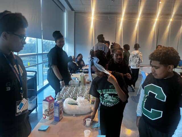 Chapter member engage with students about different types of milk.