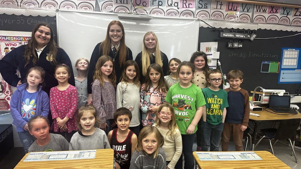 Cambridge FFA members smile with elementary students who participated in the Spanish learning program. Each team read a storybook they created, brought a piñata and taught a lesson related to an agriculture topic. Photo courtesy of Trenton Taber.