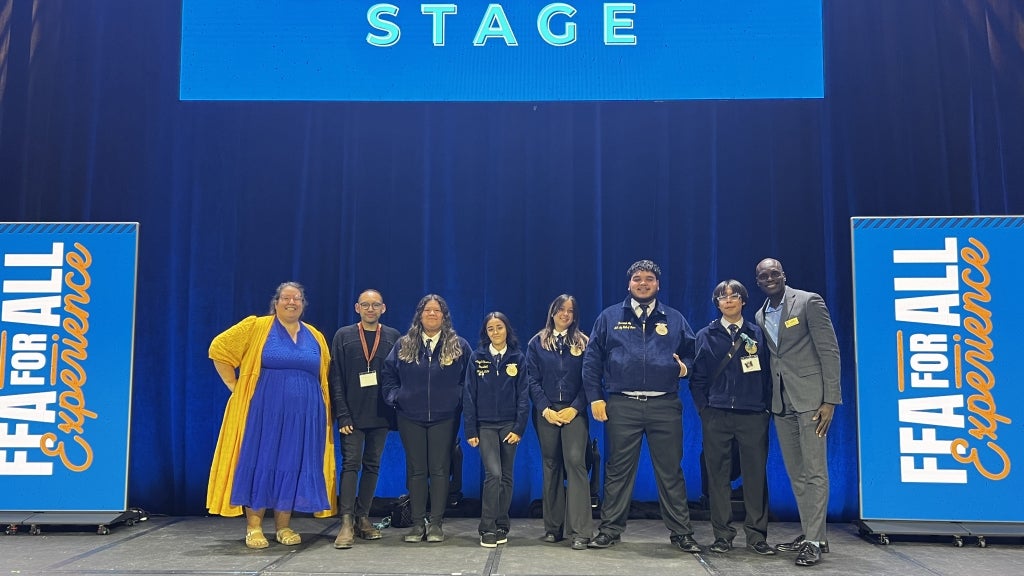 Carol Travis (far left) and New Horizons FFA members meet past National FFA president Corey Flournoy (far right) at the FFA for All Experience held during the 97th National FFA Convention & Expo. Photo courtesy of Carol Travis.