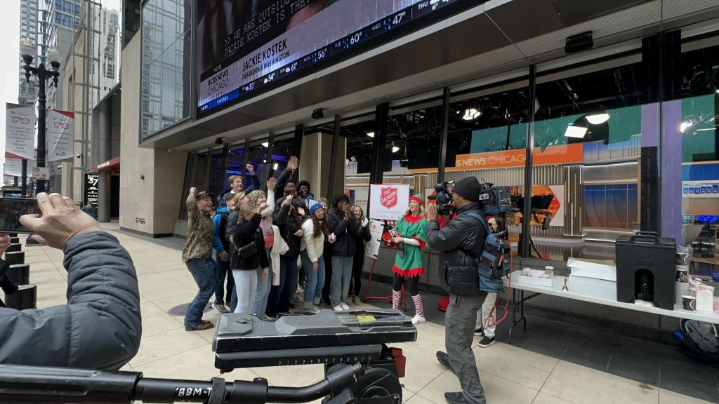 Excited members pose for the camera in front of the CBS building in Chicago.