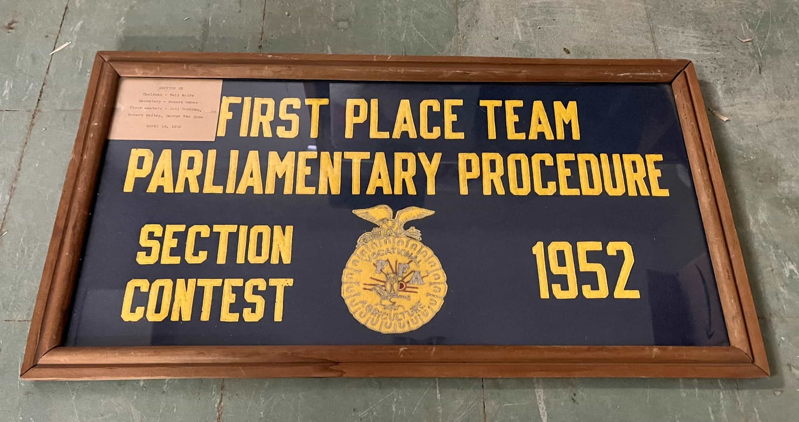 A 1952 award is displayed after being discovered by today’s North Clay FFA members.