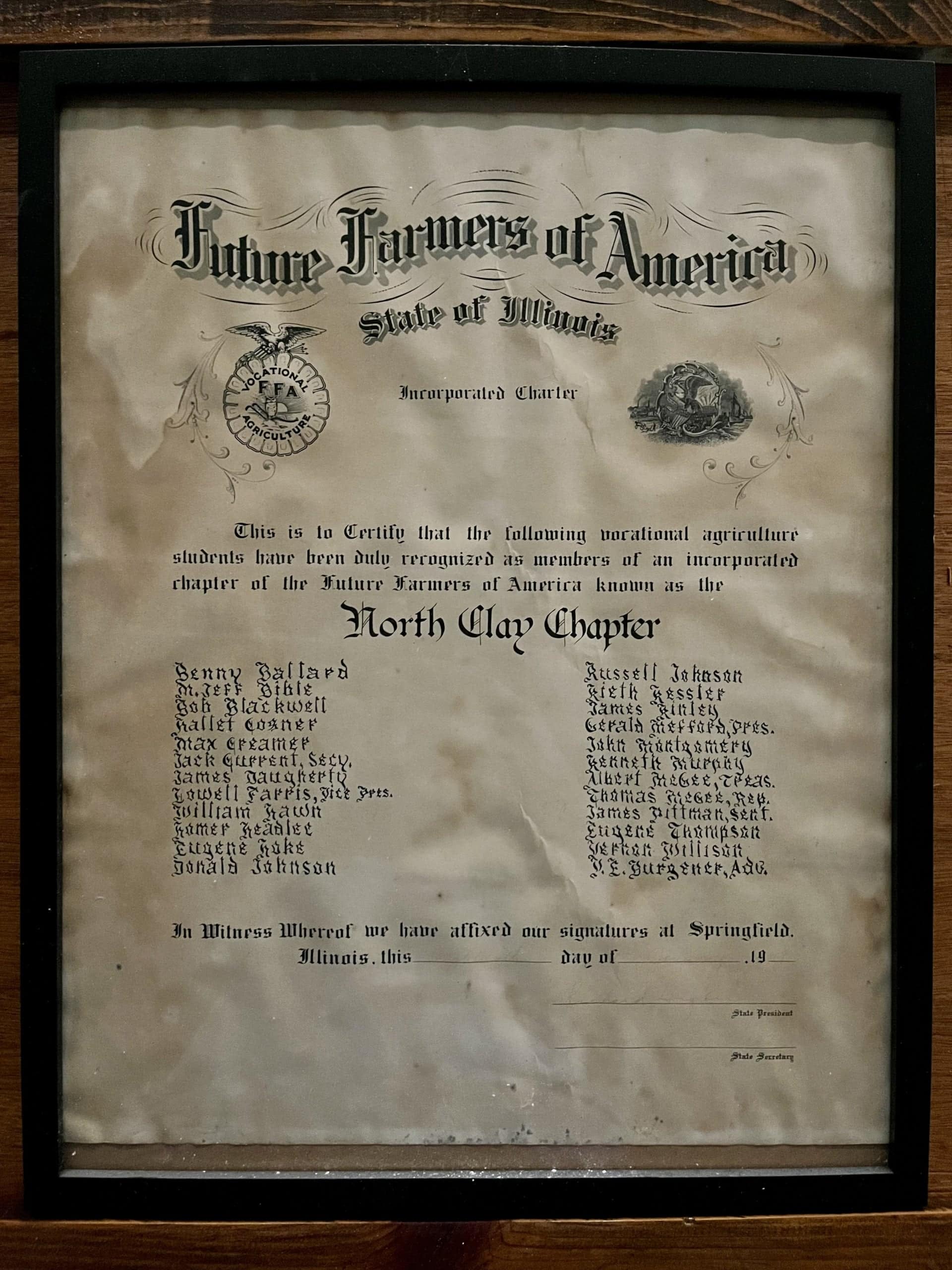 The North Clay FFA Chapter’s charter is displayed on a wall.