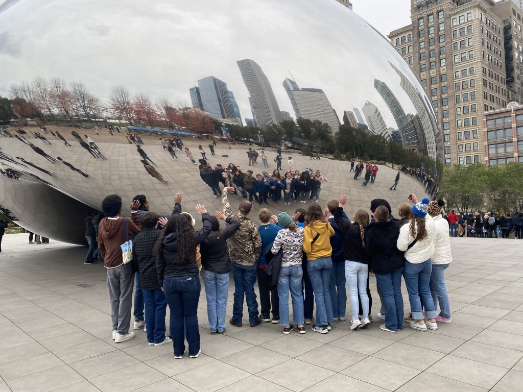 Members wave goodbye to Chicago via the Bean.
