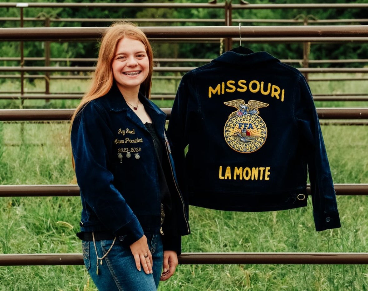 Ivy Elwell proudly stands next to her La Monte FFA Chapter jacket.