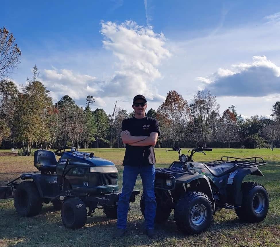 Josh Spencer poses with his mechanics projects.