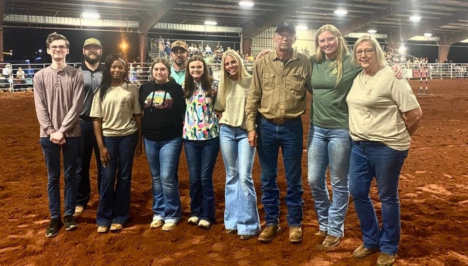 Crescent FFA members receive their scholarship during the Saturday night rodeo and stand with their sponsors and agriculture teachers. From left to right: Gavin Willams, Philip Rhodes, Vanessa Durant, Caleigh Albert, Brantley Caldwell, Amberlyn Christenbury, Jessica Cape, Jim Jarrad, Dani Rae Shore and Emily Jarrard.