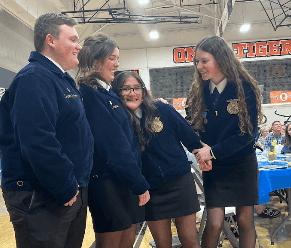 The emotional senior officers watch a slideshow about their time in FFA at the chapter banquet.