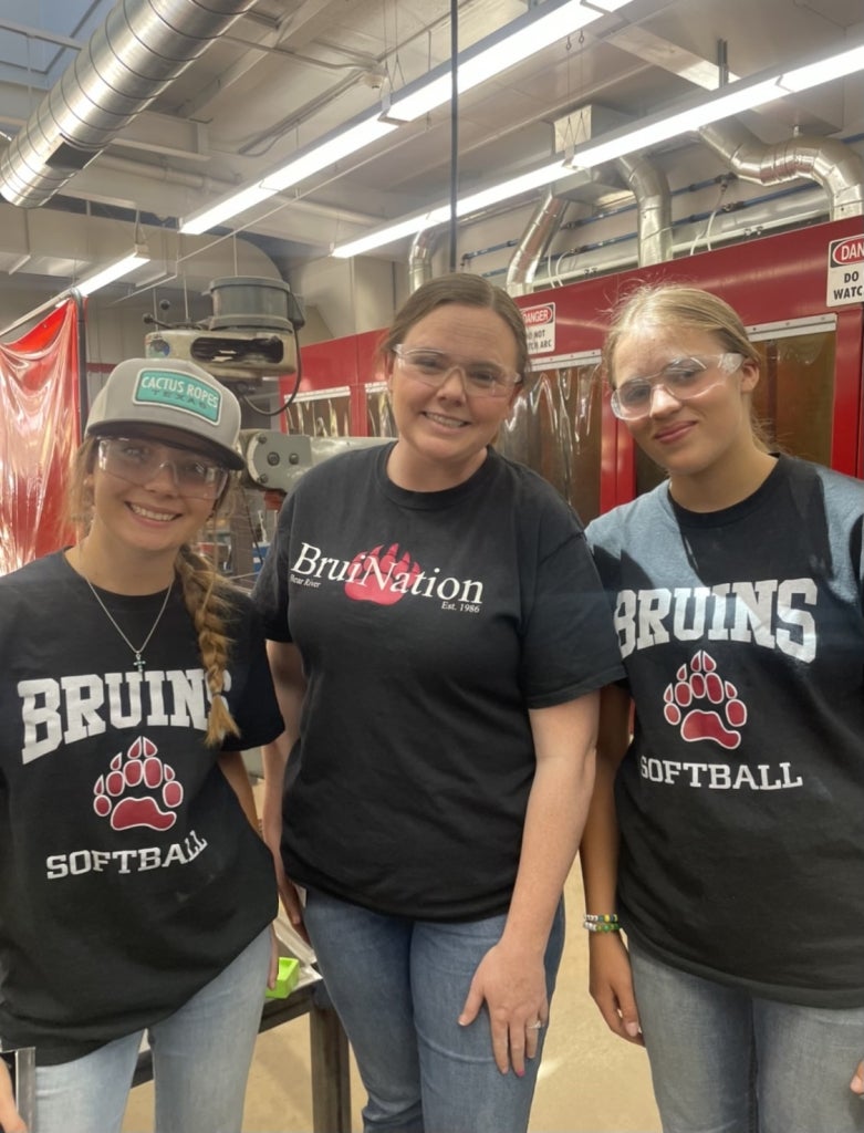 Hannah Solomon (left), Ms. Shannon (center) and Wyatt Fowler (right) have fun in the agricultural mechanics shop at Bear River.