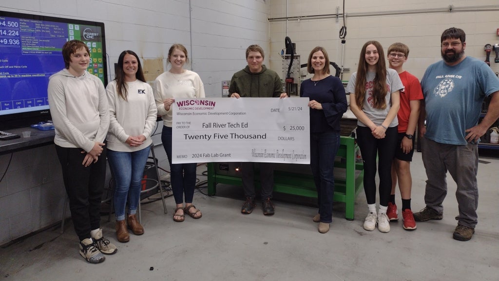 Fall River High School agricultural and technology education students Colton Dykstra (far left), Connor Dykstra (fourth from left), Clara Mickelson (third from right) and Daniel Mickelson (second from right) and their instructor, Ryan Seichter (far right), accept a grant that was used to provide hands-on learning opportunities. EK representatives Dani Geiger (second from left) and Emily Weinberger (third from left), as well as community supporter Christine Lindner (fourth from right), also attended the check presentation. Photo courtesy of Christine Lindner.