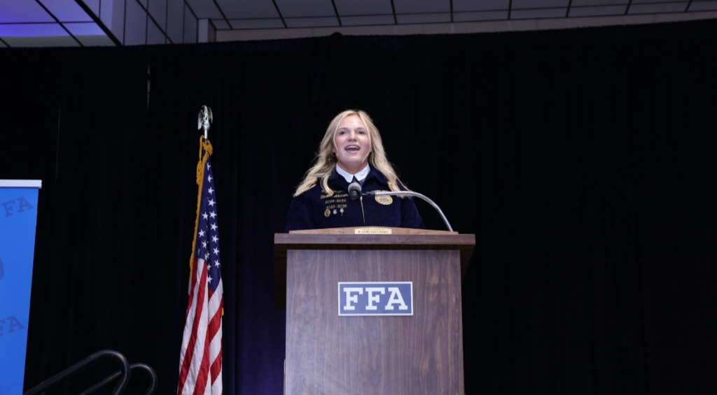 Boyer stands at the podium during the Friends of the FFA Luncheon and performs her “Why I Desire” speech.