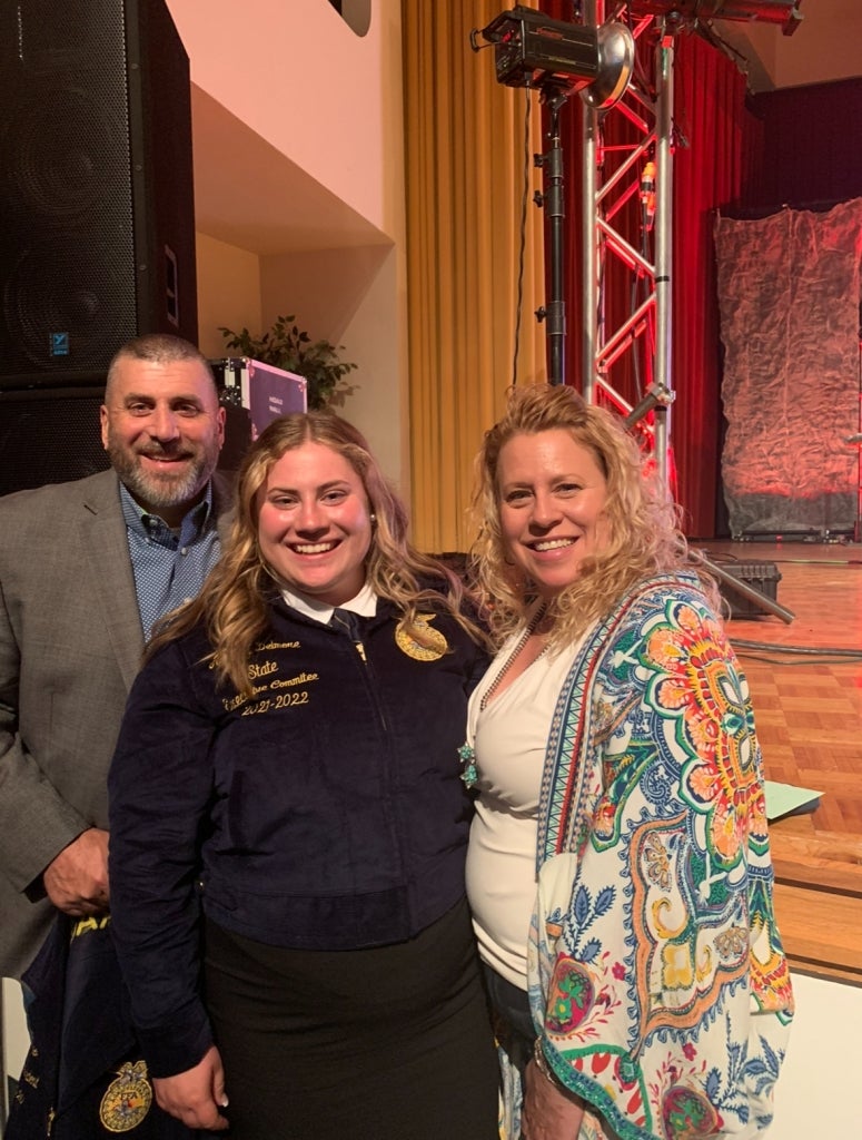 Ainsley Delmore (center) with her parents, Robert and Lynn Delmore.