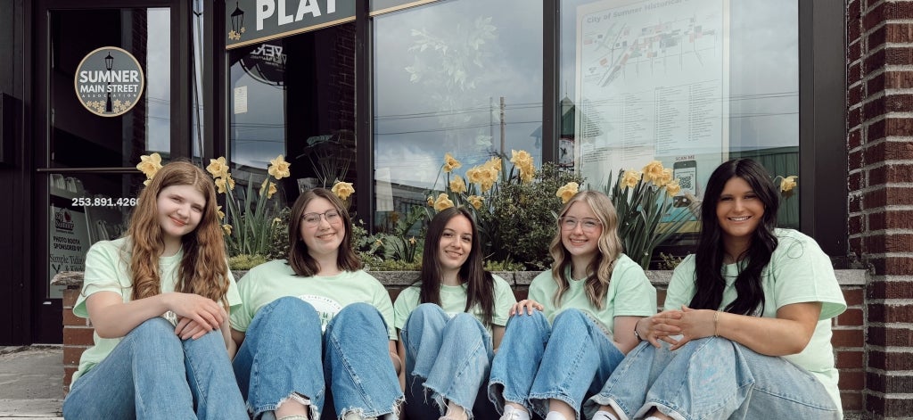 Sumner FFA members Cortlynn Joyce (far left), Tessie Stockwell (second from left), Lainey Orm (center), DaniRose Huss (second from right) and Olivia Anderson (far right) smile in front of daffodils planted in their hometown. Photo courtesy of Trent Oney.