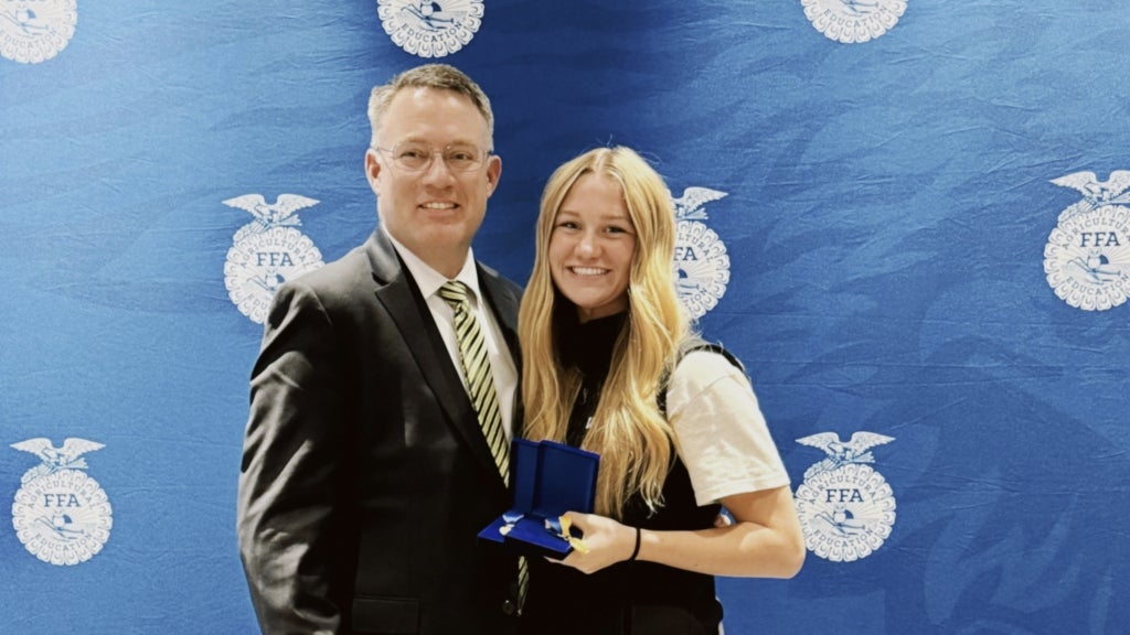 Lucy Barney (right) celebrates her hard work paying off with Rigby FFA advisor Lex Godfrey (left). Photo courtesy of Lucy Barney.