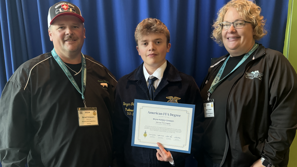 When Bryce Grossen (center) accepted his American FFA Degree, he became the fourth and final member of his family to receive this accomplishment. Photo courtesy of Kari Grossen.