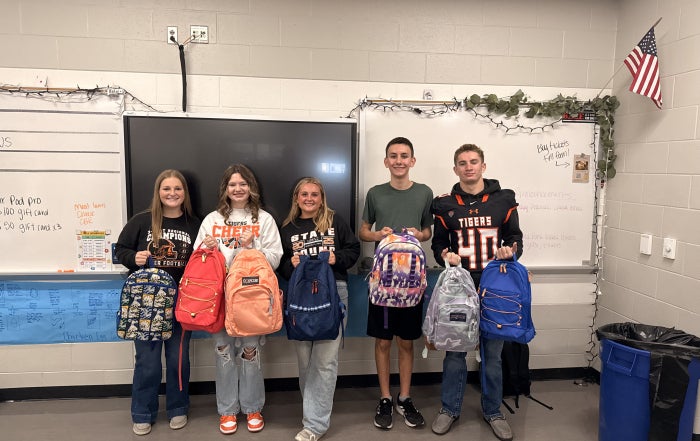 The Liberty Center FFA Service Committee presents the first backpacks of the 2025-26 school year. Pictured, from left: Mackenzie Keller, Alyvia Meyer, Maddie Sattler, Cole Bauman, and Baxter Barrett.