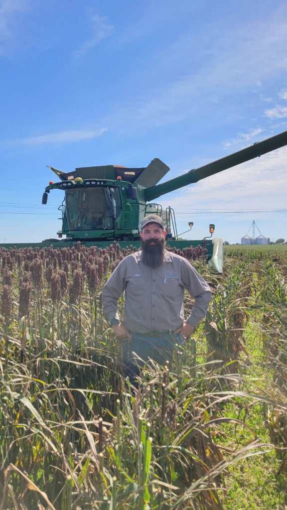 Zack Rendel stands in his field, living out the FFA motto of “Living to Serve.”