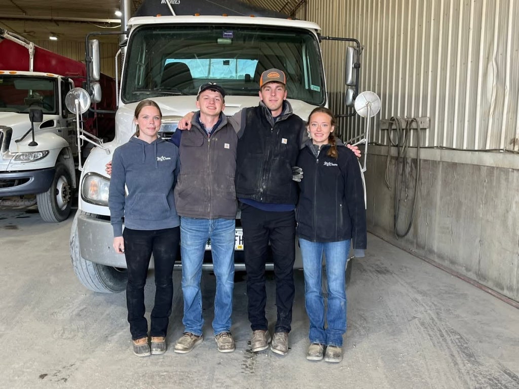Mars Hill FFA members and potato truck drivers Harleigh Allen, Caden Bell, Dayton Taylor and Hannah Shaw smile in front of a potato truck.