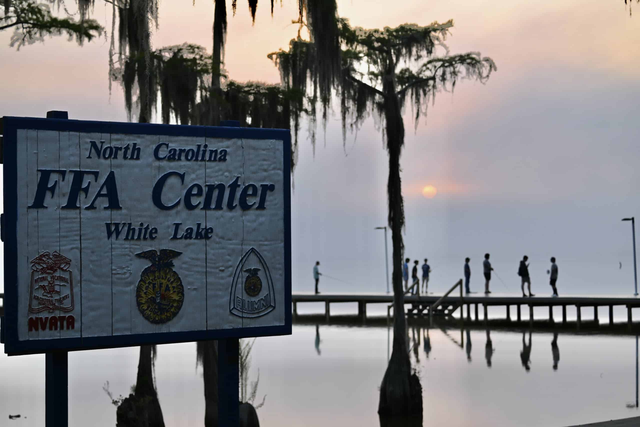 Students fish off the dock early in the morning at Wildlife Camp.
