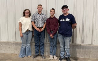 Callie Rosner (far left) poses with students participating in the Cheyenne Warrior Goat Program.