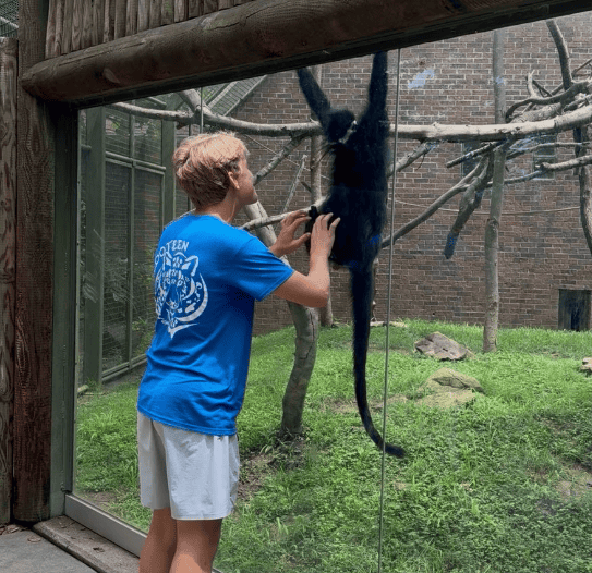 Burgener plays with Badu, the langur. This is one of his favorite animals in the entire zoo.