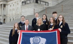 Members of the Cheyenne Frontier FFA post with Senators Cynthia Lummis and John Barasso in front of the United States Capitol