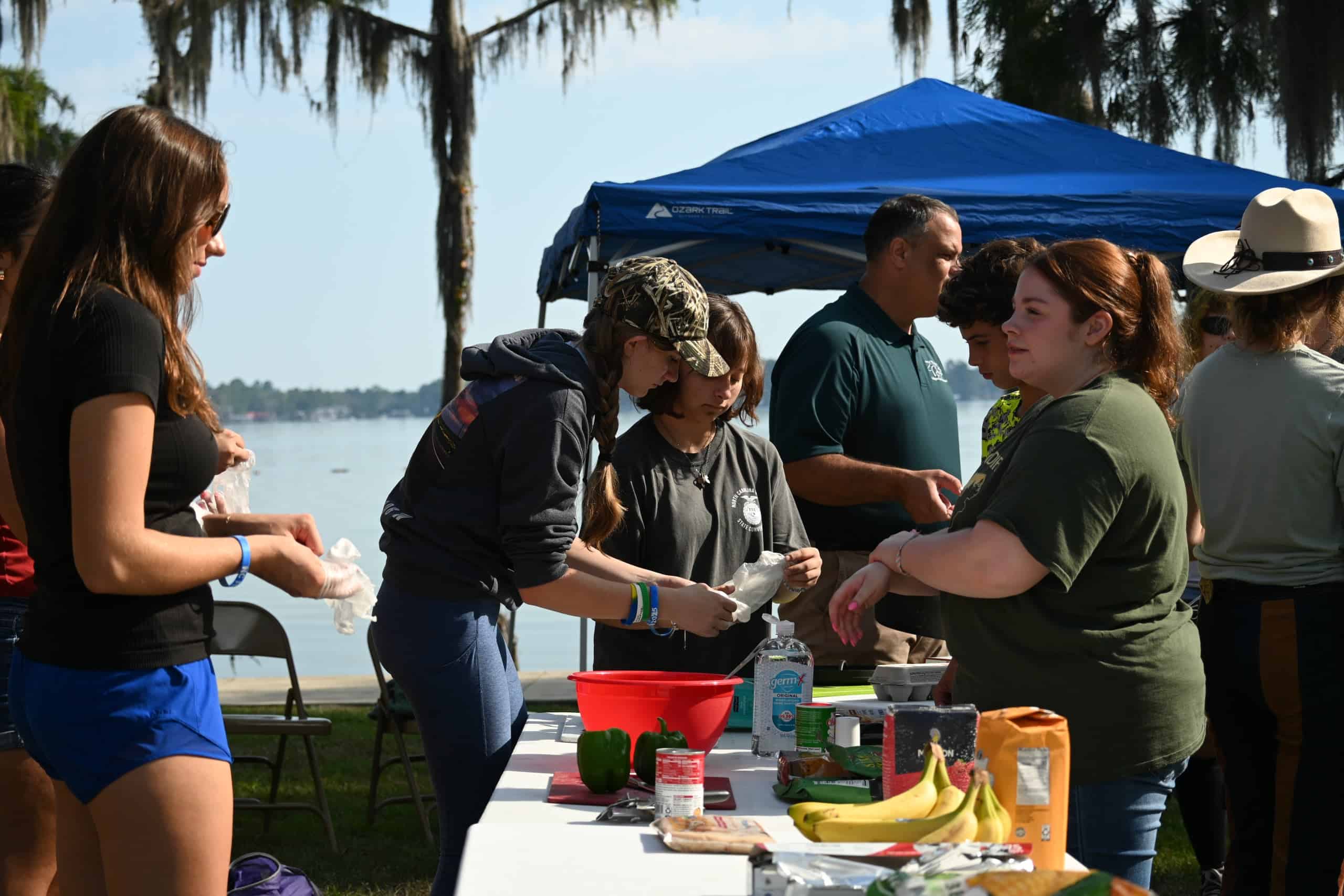 Students prep hash brown casserole during the outdoor cooking small group breakout.