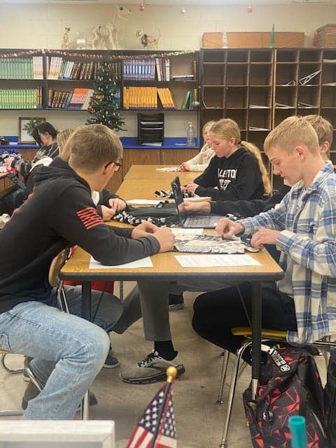 Freshmen Fullerton FFA members cut and tie fleece blankets that will be be donated to their local veterinary clinic. Photo courtesy of Josie Loseke.