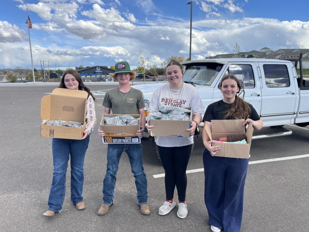 Members of the Cheyenne Frontier FFA Chapter’s Building Communities Committee pose outside of Laramie County Senior Services with care kit components.