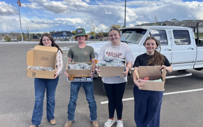 Members of the Cheyenne Frontier FFA Chapter’s Building Communities Committee pose outside of Laramie County Senior Services with care kit components.