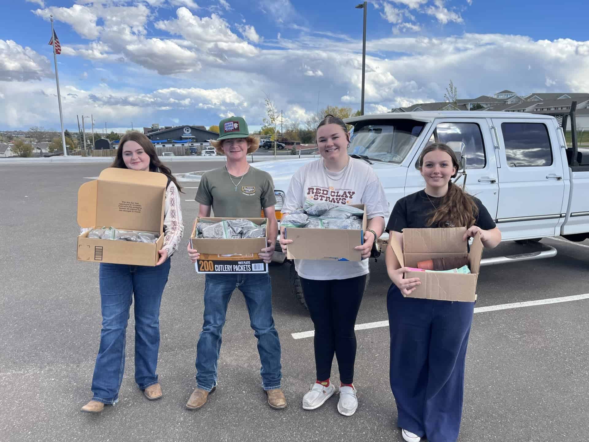 Members of the Cheyenne Frontier FFA Chapter’s Building Communities Committee pose outside of Laramie County Senior Services with care kit components.