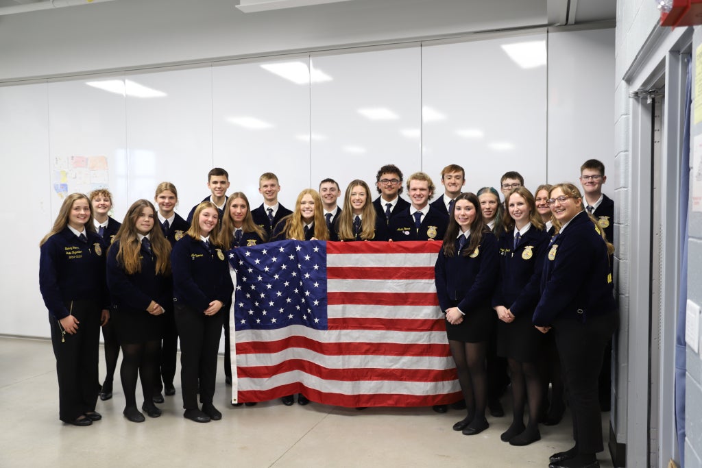 Bureau Valley FFA members and section officers pose for a photo after collecting their flags.