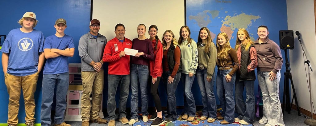 Ankenbrand presents grant money to the 2024 agricultural leadership class.